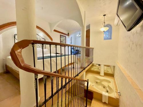 a bathroom with a staircase and a sink in a room at Hotel Frances in Guadalajara