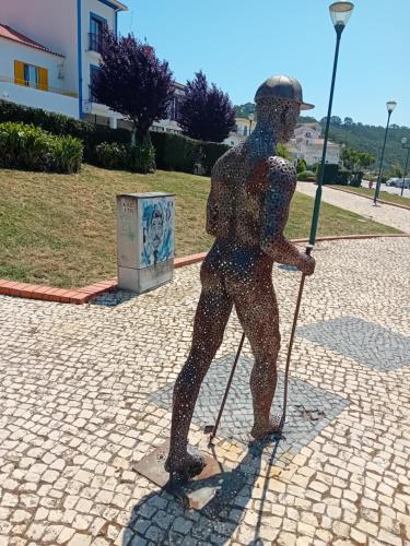 a statue of a person holding a baseball bat at Sol Mar in Odeceixe