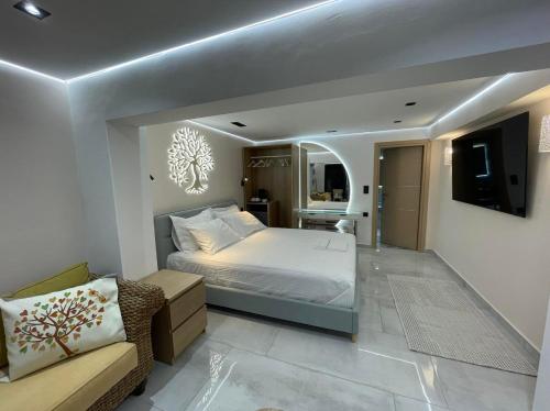 a large bedroom with a bed and a couch at Elements of Diros in Pirgos Dhirou