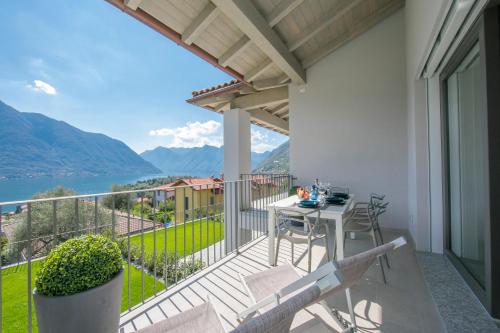 a balcony with a table and chairs and a view at Sant' Agata Bellavista in Ossuccio