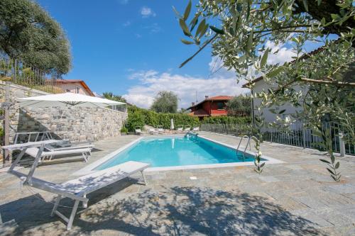 a swimming pool with a chair and an umbrella at Sant' Agata Bellavista in Ossuccio