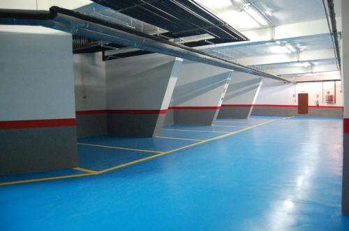 a large room with a blue floor in a building at Apartamentos Boabdil in Sierra Nevada