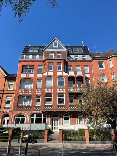 a large red brick building on a city street at Luxus Penthouse Waterview in Kiel