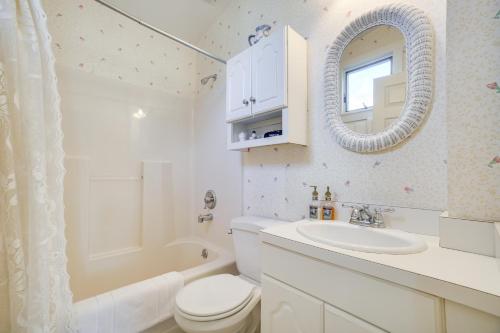 a bathroom with a toilet and a sink and a mirror at The Porch House Located in Historic Village in Granville