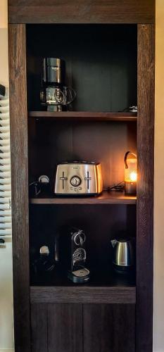 a shelf with a toaster and other kitchen items at Marie à la Campagne in Dolembreux