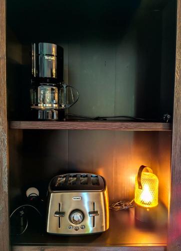 a toaster sitting on a shelf next to a lamp at Marie à la Campagne in Dolembreux