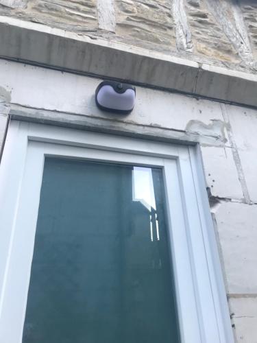 a door with a blue handle on a building at Home Antonin & Maye in Tonnerre