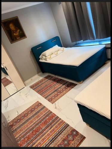 a small bedroom with a bed and two rugs at Schöne und gemütliche Wohnung in Holzwickede in Holzwickede