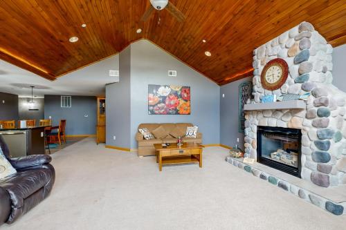 a living room with a large stone fireplace at Sunset Condominiums: The View in Arkdale