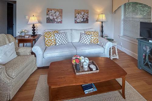 a living room with a couch and a coffee table at Stone Cottage 1973 in Lake Junaluska