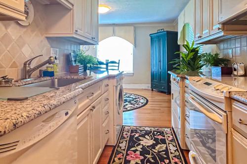 a kitchen with white cabinets and a sink at Stone Cottage 1973 in Lake Junaluska
