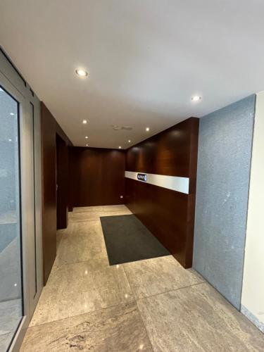 a hallway of a building with a door and a rug at Warsaw Oxygen Apartment in Warsaw