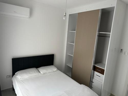 a small bedroom with a bed and a closet at Sessiz tesisi in Kyrenia