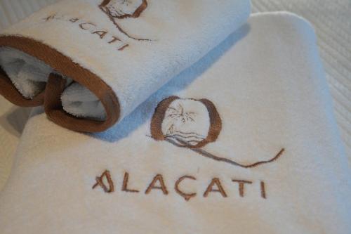 a towel with the name albanian written on it at Q Alaçatı Luxury Hotel in Cesme