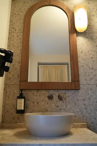 a bathroom sink with a large mirror above it at Q Alaçatı Luxury Hotel in Cesme