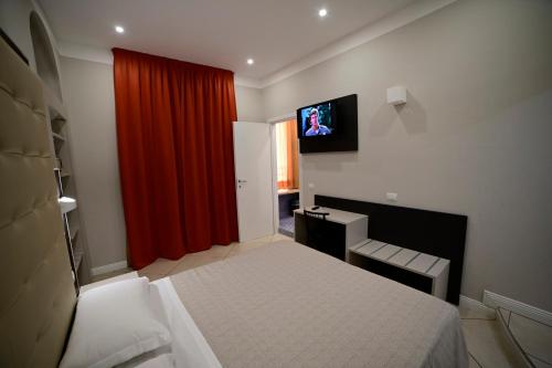 a bedroom with a bed and a red curtain at Hotel Demo' in Milan