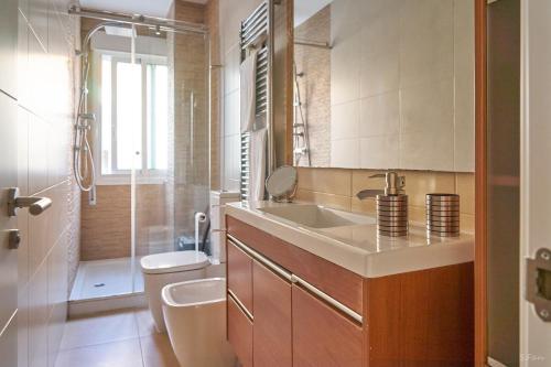a bathroom with a sink and a toilet and a shower at O Forte in Cangas de Morrazo
