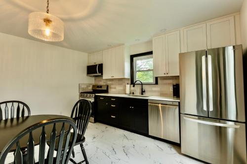 a kitchen with a stainless steel refrigerator and a table at Speedway Finish Line House in Indianapolis