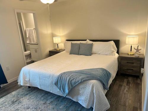 a bedroom with a large bed with two night stands at New With heated Pool and Pier! Ideal for 2 Families! in Cape Coral