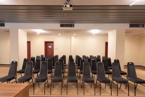a row of chairs in a large room at Wyndham Cluj in Cluj-Napoca