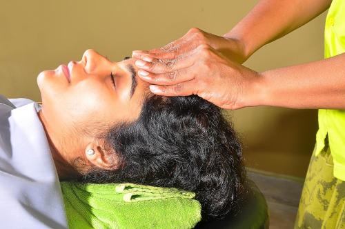a man getting his hair washed at a hair salon at The Long Beach Resort & Spa in Koggala
