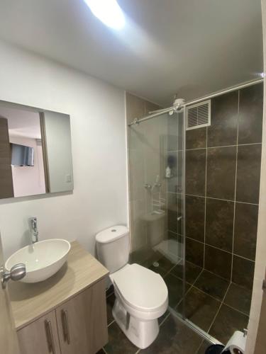 a bathroom with a toilet and a sink and a shower at Edificio Urban Frente universidad Autónoma in Manizales