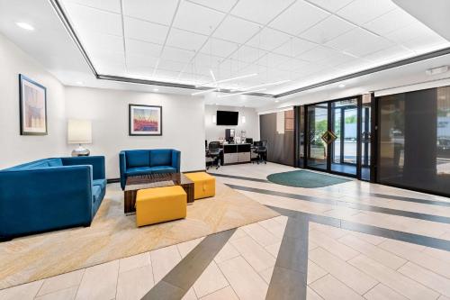 a lobby with blue chairs and a couch and a table at Best Western Inn at Ramsey in Ramsey