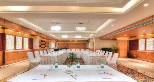 a conference room with white tables and chairs and windows at Best Western Plus Chandigarh Mohali in Mohali