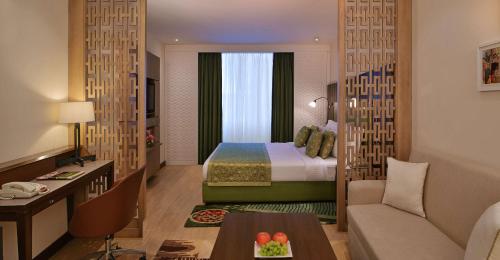 a hotel room with a bed and a desk at Best Western Maryland in Chandīgarh