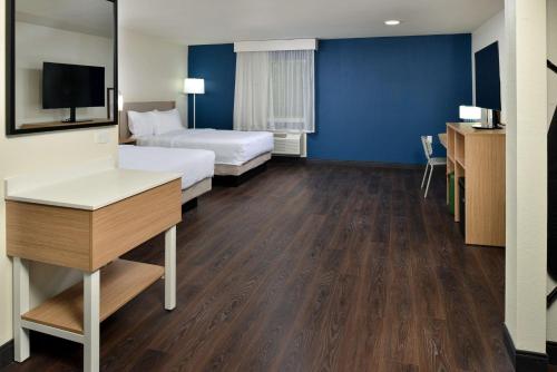 a hotel room with a bed and a desk at Spark By Hilton Dallas Medical District Love Field in Dallas