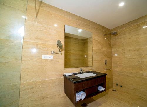 a bathroom with a sink and a mirror at Best Western Ashoka in Hyderabad