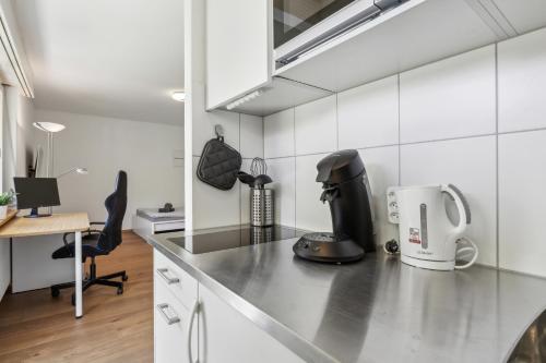 a kitchen with a counter top with a coffee maker at Pearlstay - Quiet Location Workplace Parking Washer in Schaffhausen