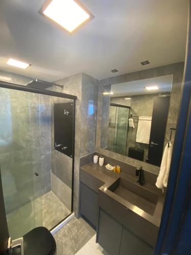 a bathroom with a sink and a shower at Golden Tower - Flat a Beira Mar in Natal