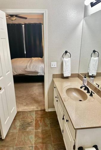 a bathroom with a sink and a bedroom with a bed at Comfy 2 bed 2 bath Phoenix Paradise with Pool and Gym in Phoenix