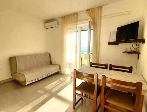 a living room with a table and chairs and a couch at Relax A 3 in Zaboric