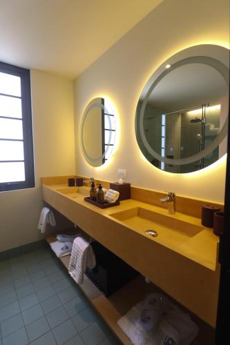 a bathroom with a sink and a large mirror at Rodona Hotel in Mexico City
