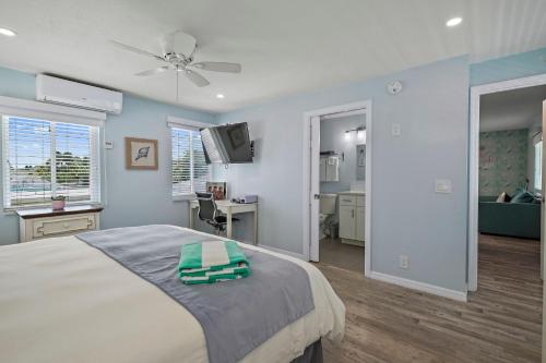 a bedroom with a bed with a ceiling fan at The Pearl Cabana Club in St Pete Beach