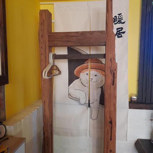 a painting of a person with a hat on a wall at 兔窩很Chill in Yilan City