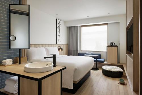 a hotel room with a bed and a sink at Fairfield by Marriott Kyoto Minamiyamashiro in Minamiyamashiro