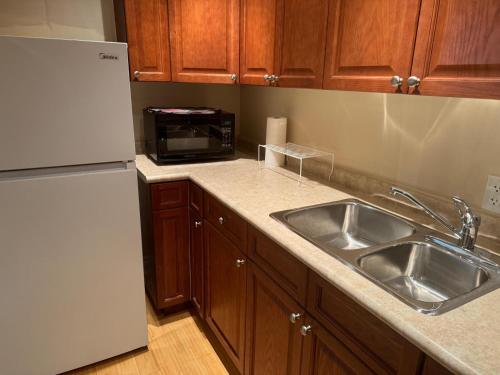 a kitchen with a sink and a refrigerator at Luxury Apartment Living in Mississauga