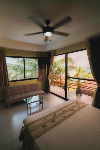 a bedroom with a bed and a ceiling fan at Villa de Gloria in Dauis