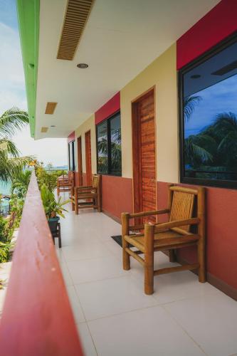 a porch with benches and a view of the ocean at Villa de Gloria in Dauis