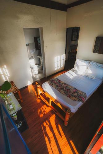 a bedroom with a large bed and a wooden floor at Villa de Gloria in Dauis