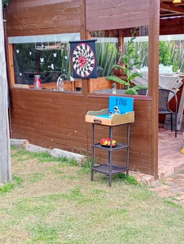 a table with a box on it next to a wall at Cabaña Los Linos in Guasca