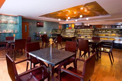 a dining room with tables and chairs in a restaurant at The Westin Dhaka in Dhaka