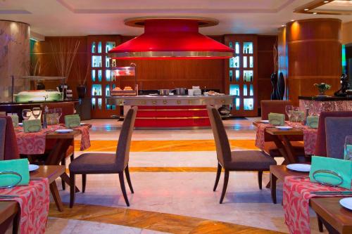a restaurant with tables and chairs and a red ceiling at The Westin Dhaka in Dhaka
