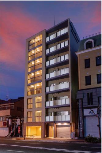 a building on a street in front of a building at Shinkou House UE - Newly Built Secure and Hypoallergenic in Osaka