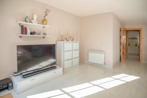 a living room with a large flat screen tv at Comodidad y estilo en Gava near the beach 10 minutes in Viladecáns