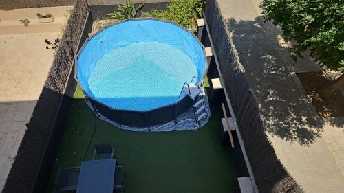 an overhead view of a swimming pool with a blue cover at Comodidad y estilo en Gava near the beach 10 minutes in Viladecáns