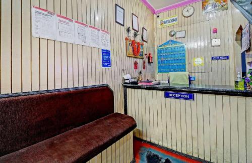 a restaurant with a bar and a bench in a room at SPOT ON Sahara lodge in Bengaluru